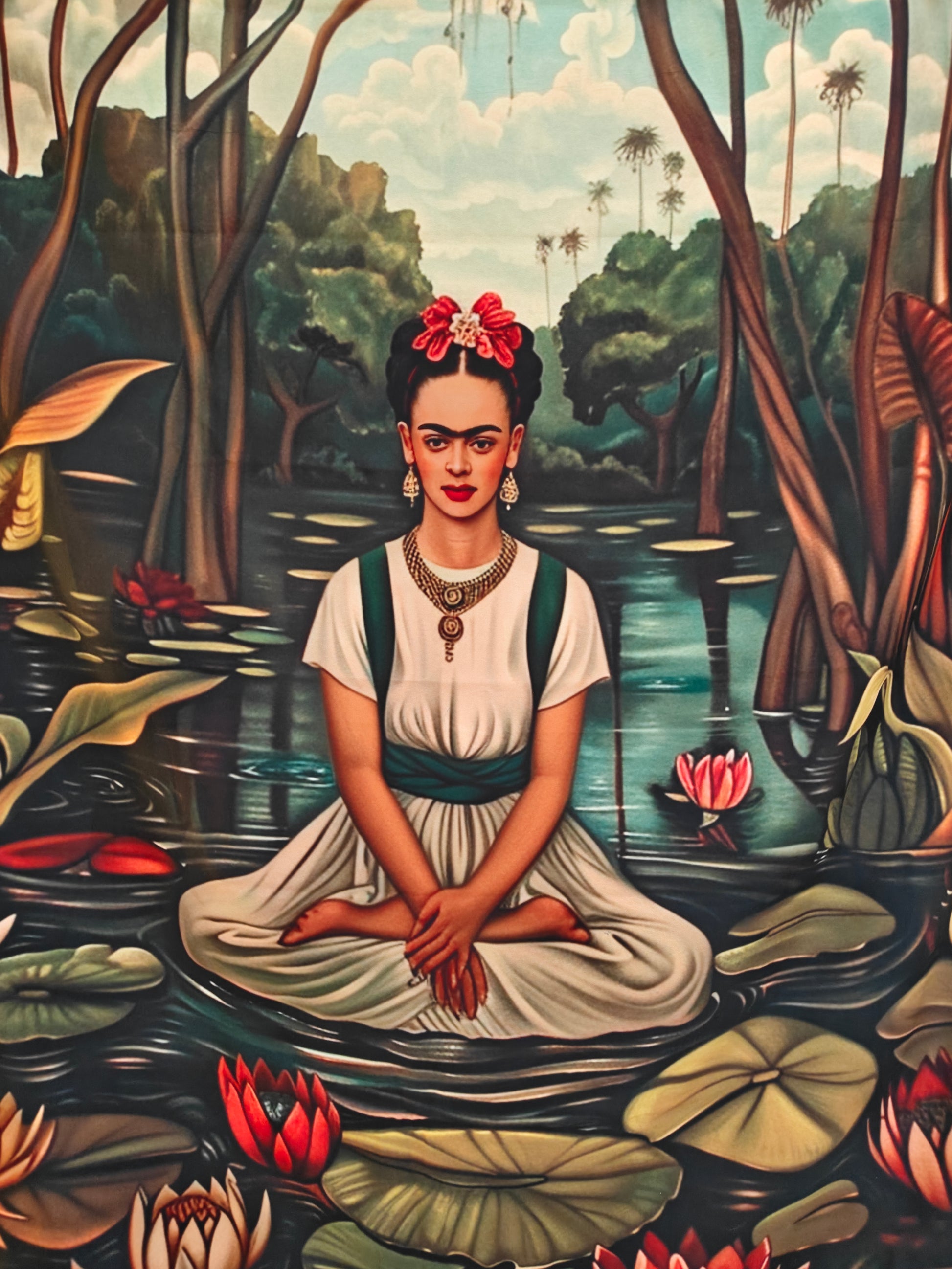 Colourful boho wall tapestry of a Frida-inspired figure in a Buddha pose hanging above a cosy seating area